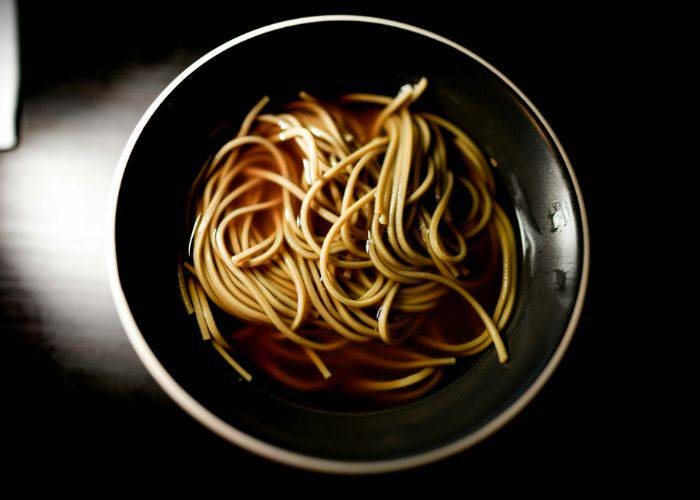 A top-down shot of soba noodles in broth.